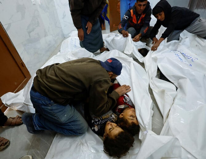 A relative mourn over the bodies of Palestinian children killed in Israeli strikes, in Khan Younis in the southern Gaza Strip on Oct. 25, 2024. (Reuters)