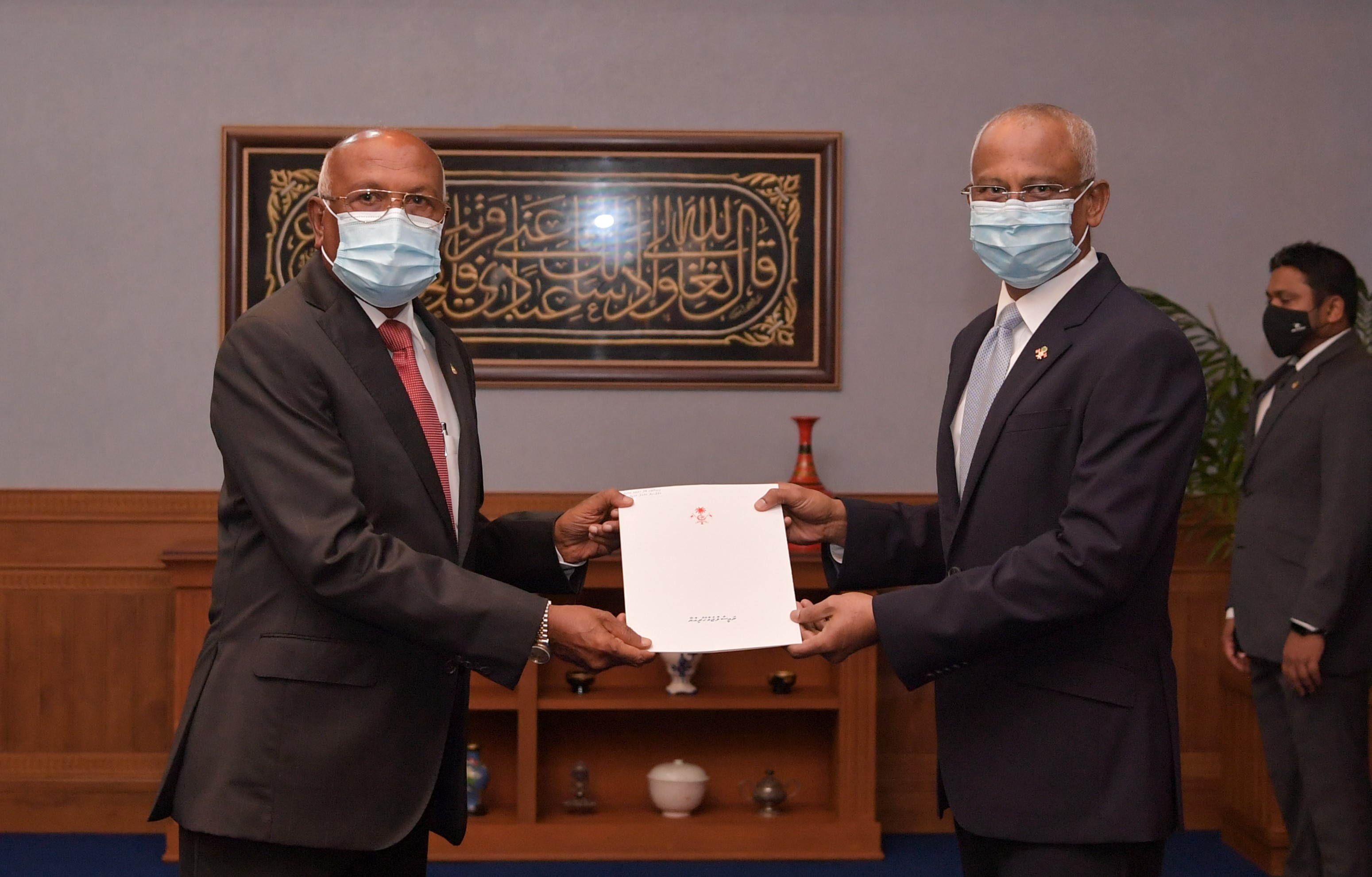 President Ibraihm Mohamed Solih presenting Ahmed Naseem with his Letter of Appointment.