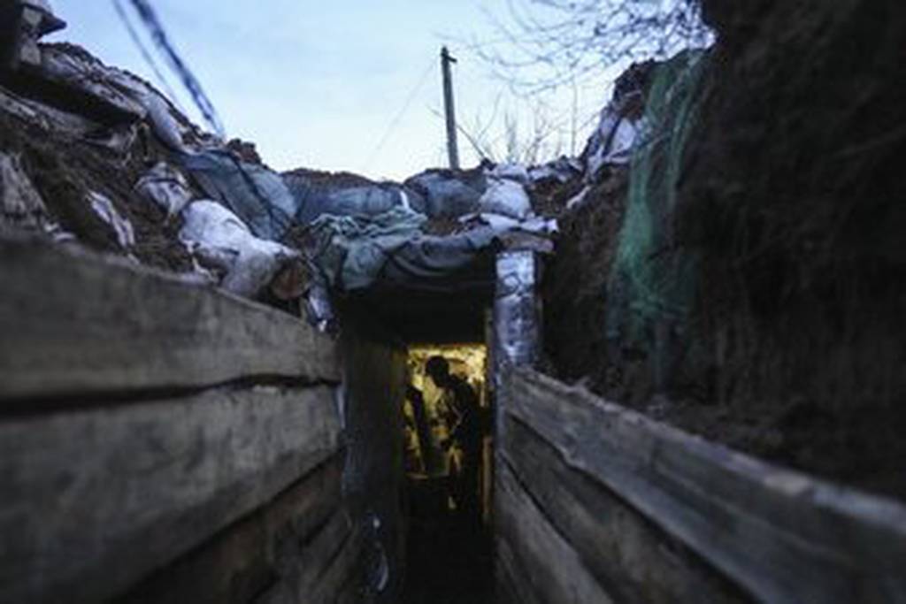 A Ukrainian serviceman stands in a shelter on a position at the line of separation between Ukraine-held territory and rebel-held territory. (AP Photo)