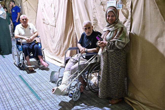 Injured Palestinian men evacuated from the Gaza Strip sit on wheelchairs inside an Emirati floating hospital in the Egyptian port of Al-Arish. (File/AFP)