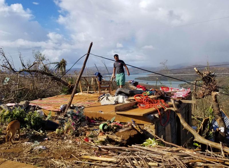 A resident stands on the ruins of his house caused by Super Typhoon Rai, in San Jose, Dinagat island, Philippines on Sunday. (Photo: AFP)