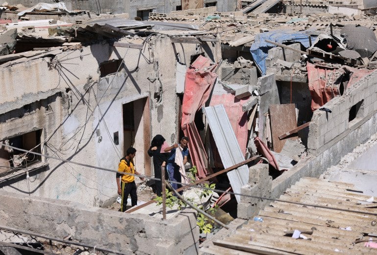 Palestinians check the aftermath of Israeli airstrikes in Rafah in the southern Gaza Strip [Said Khatib/AFP]