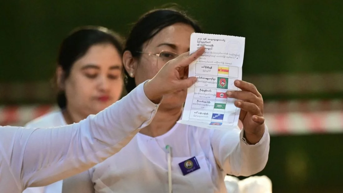 Members of Myanmar’s Union Election Commission (UEC) count ballots after the closing of polls at a polling station in the third phase of Myanmar’s general election in Yangon. Photo: AFP