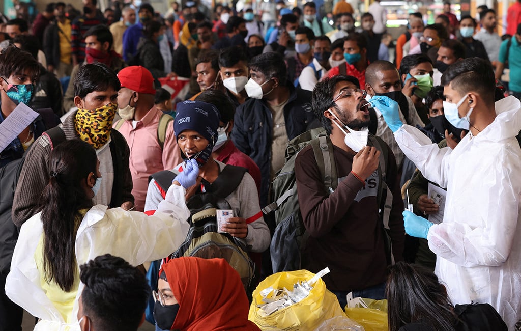 Health workers collect swab samples during a rapid antigen testing campaign for Covid-19, at a railway station in Mumbai .