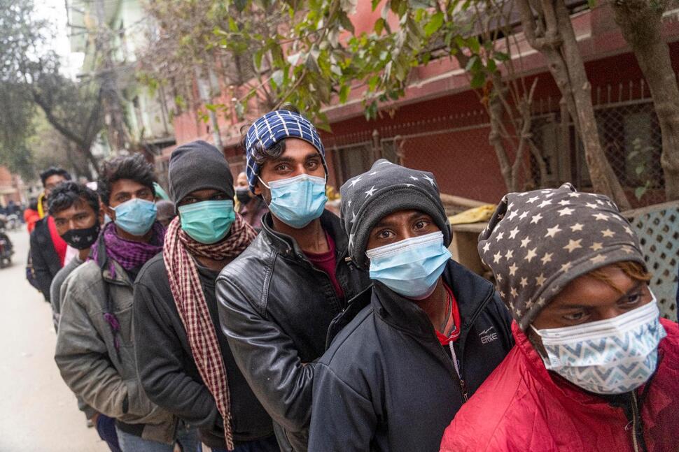 People stand in a queue to receive the vaccine after the Nepalese government made vaccination cards mandatory for people to access public services in Kathmandu, Nepal.