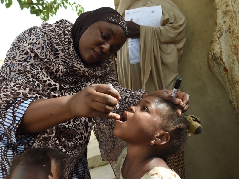 A health worker immunizes a child during a polio vaccination campaign in northwest Nigeria in 2017. (AFP)