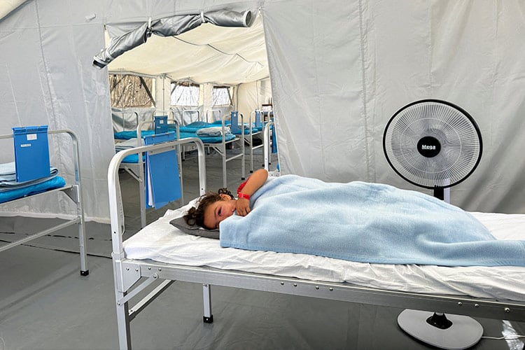 A child lies inside the International Red Cross field hospital in southern Gaza on Friday. Reuters