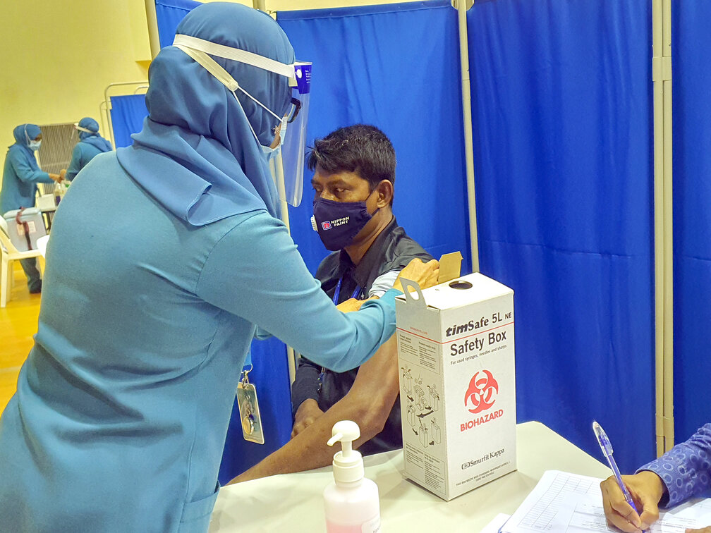 A person receiving the Covishied vaccine from Male' City.