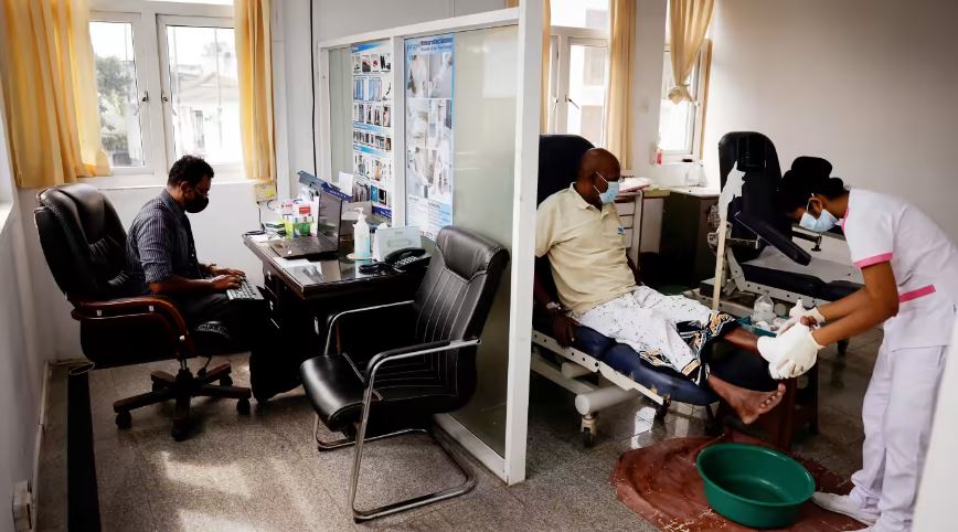 A doctor prepares to inspect a patient in Colombo. (Reuters)