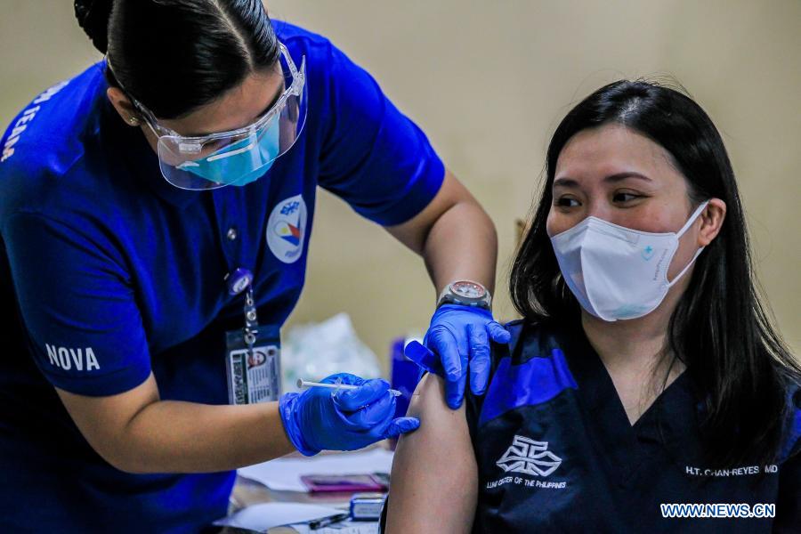 A health worker receives a dose of COVID-19 vaccine in Manila, Philippines.