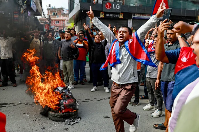 Protesters surround burning tires during a rally against a deadly police crackdown in Kathmandu, Nepal, Sept. 9. (Prabin Ranabhat/AFP/Getty Images)