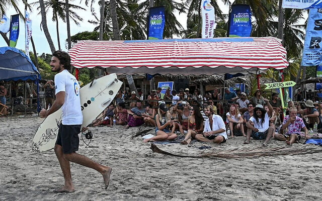 Spectators watch a surfing competition at Arugam Bay in the east of Sri Lanka on September 27, 2020. (Photo: AFP)