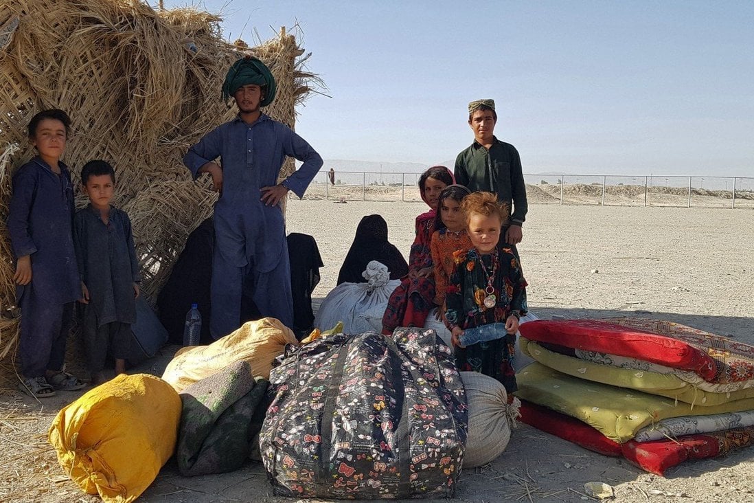 A stranded Afghan family waits for the reopening of the Pakistan-Afghanistan border crossing point in Chaman on Friday. Photo: AFP