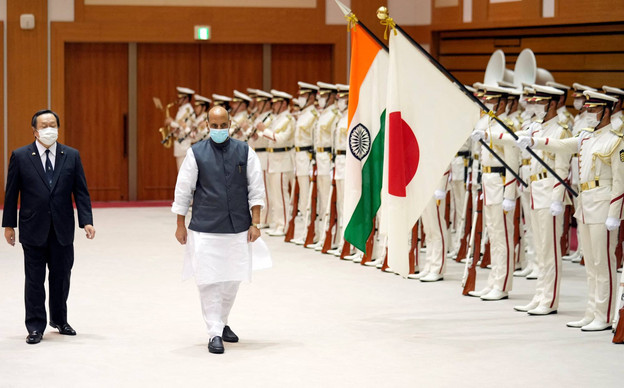 Japanese Defense Minister Yasukazu Hamada and his Indian counterpart, Rajnath Singh, attend an honor guard ceremony prior to their meeting in Tokyo on Thursday.
