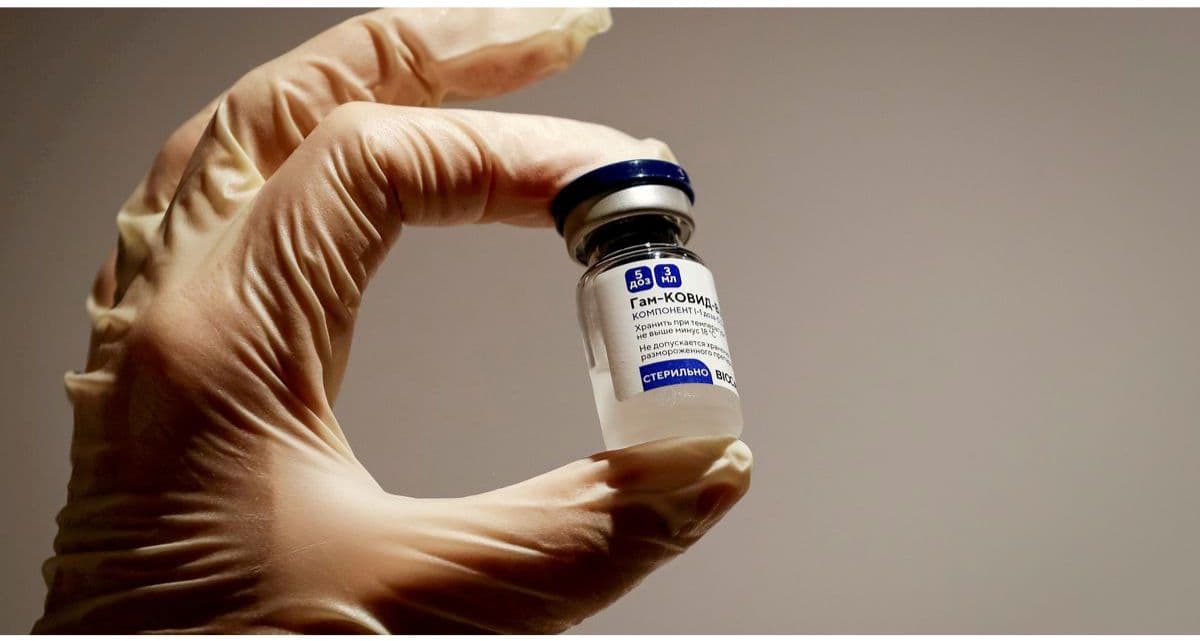 A medical specialist holding a vial of Sputnik V vaccine.