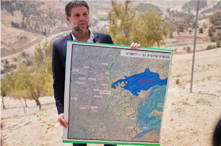Israeli Finance Minister Bezalel Smotrich holds a map that shows the E1 settlement project. Ohad Zwigenberg/The Associated Press