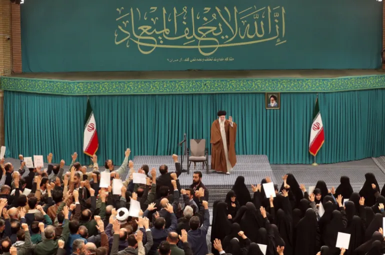 Iran’s Supreme Leader Khamenei waves to family members of killed armed forces holding up images of the soldiers killed in the Israeli attack [Courtesy: website of Iranian supreme leader]