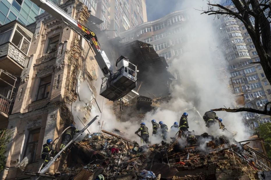 Firefighters at the scene of a drone attack in Kyiv, Ukraine, on Monday.