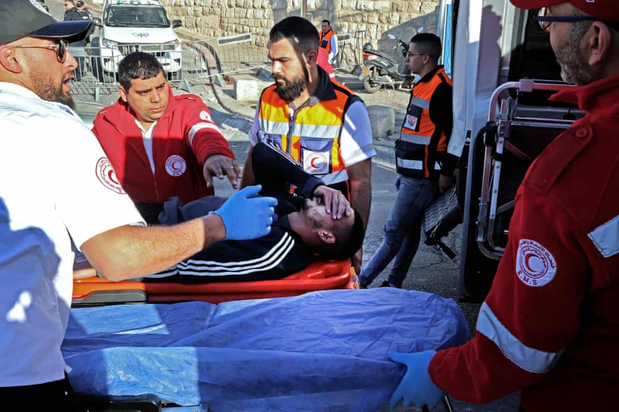 Rescuers evacuate an injured man during the clashes. (Photo: AFP)