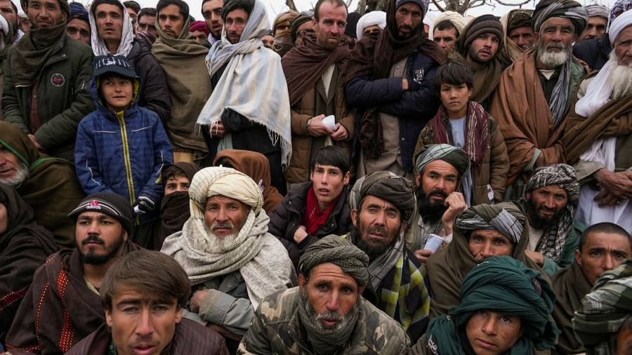 Hundreds of Afghan men gather to apply for the humanitarian aid in Qala-e-Naw, Afghanistan on December 2021.