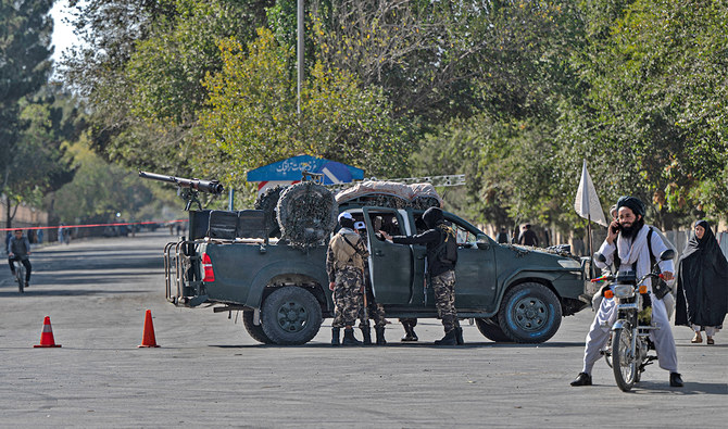 Taliban fighters stand guard as they block a road in Kabul, Afghanistan, on October 13, 2022. (AFP/File)