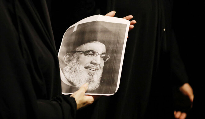 Demonstrators hold pictures of Hassan Nasrallah, late leader of the Lebanese group Hezbollah. (AFP)