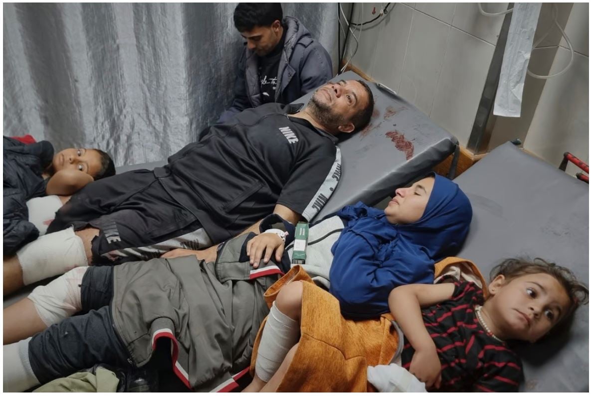 Injured Palestinians wait for treatment at the hospital following Israeli army airstrikes in Khan Younis, southern Gaza Strip, Tuesday, March 18, 2025. (AP Photo/Mohammad Jahjouh)