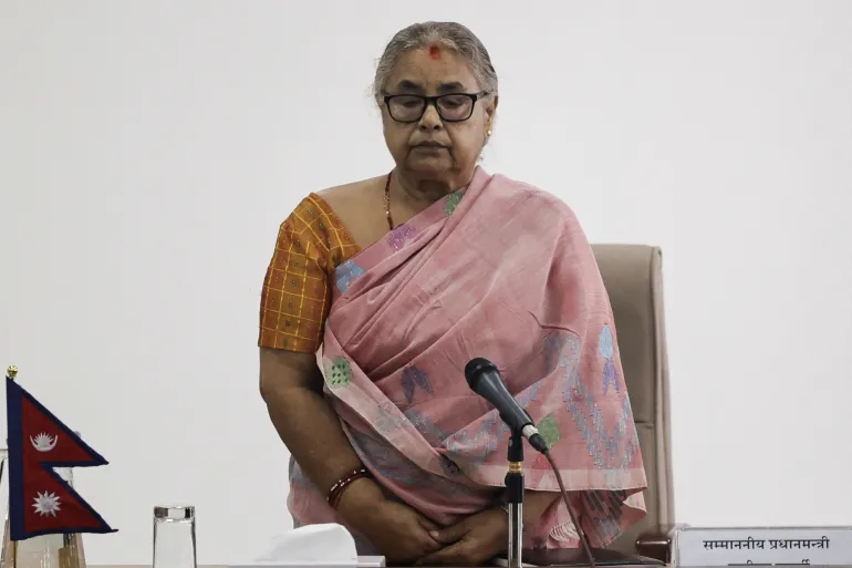 Interim Nepalese Prime Minister Sushila Karki holds a moment of silence on September 14, 2025, in memory of those killed in the protests [Navesh Chitrakar/Reuters]