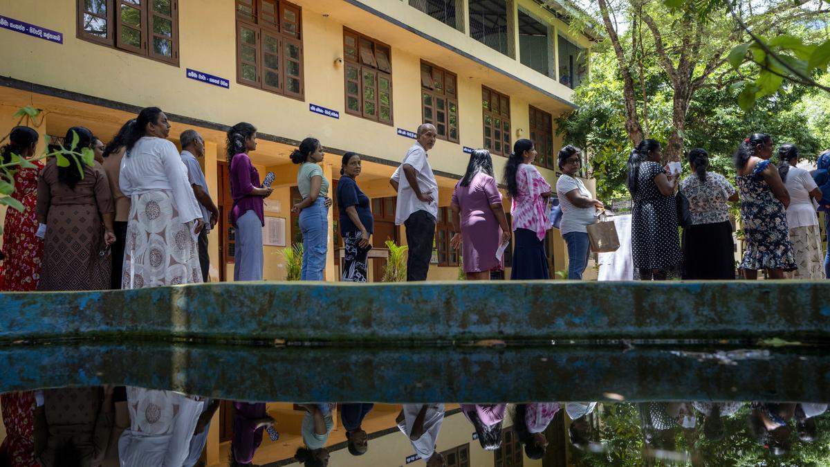 People wait in a queue to cast their votes at a polling center during the Presidential election on the outskirts of Colombo, Sri Lanka on September 21, 2024. | Photo Credit: AP