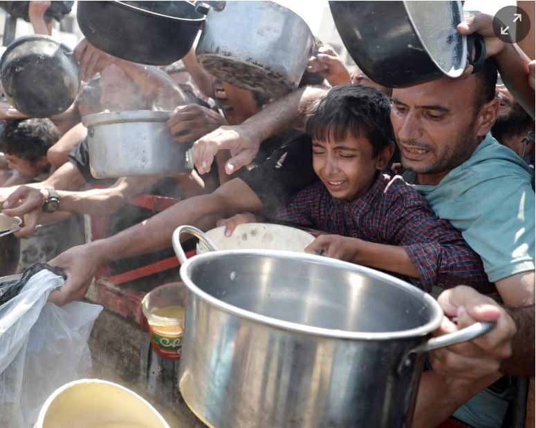 Palestinians gather to receive food from a charity kitchen in Gaza City on Monday. Photograph: Khamis Al-Rifi/Reuters